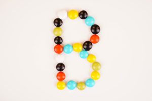 B letter with colorful milk chocolate stock image