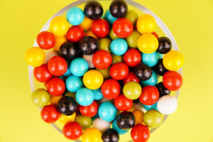 Colorful candies close up on green background