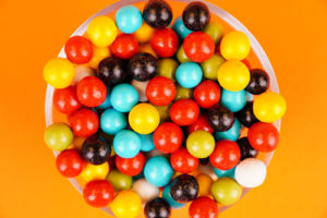Colorful candies close up on orange background