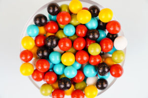 Colorful dragee candies close up on white background