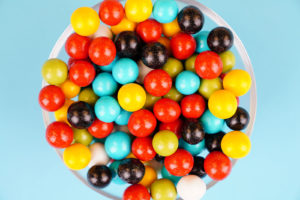 Colorful round candies close up over blue