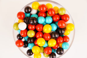 Multicolored round candies close up on white