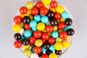 Multicolored round candies close up over blue