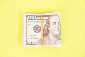 Bundle of money on bright green